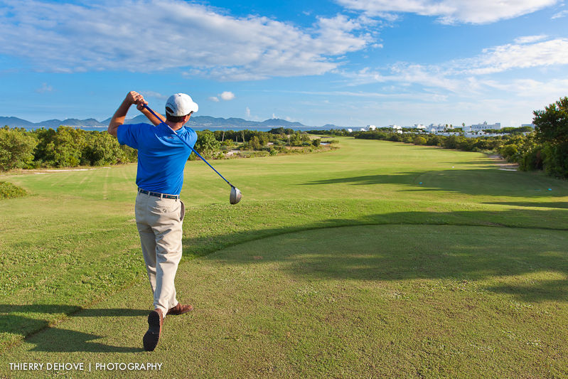 Golfer swinging on the green at Bethpage Black course